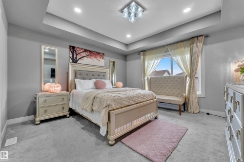 Bedroom featuring a tray ceiling, recessed lighting, and a contemporary ceiling fixture - 8025 174A Avenue, Edmonton, AB - Indoor Photo Showing Bedroom