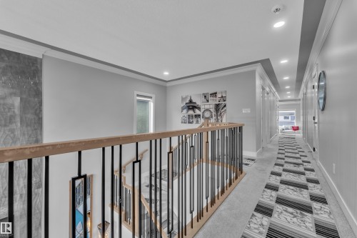 Upper-level hallway featuring recessed lighting, crown molding, and light gray wall paint - 8025 174A Avenue, Edmonton, AB - Indoor Photo Showing Other Room