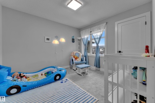 Bright room featuring light grey walls, white trim, and grey carpeting - 8025 174A Avenue, Edmonton, AB - Indoor Photo Showing Other Room