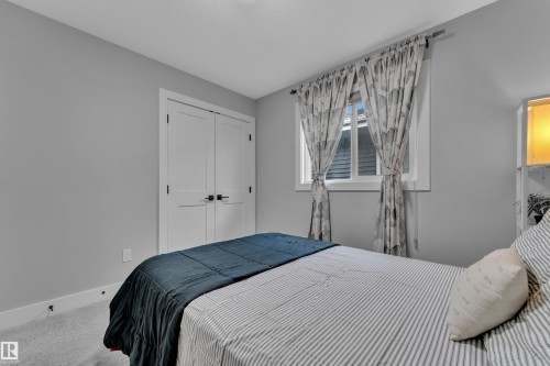 Bedroom with light gray walls, white trim, and light gray carpeting - 8025 174A Avenue, Edmonton, AB - Indoor Photo Showing Bedroom
