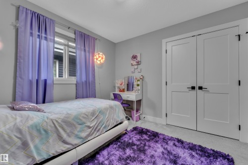 Interior room featuring neutral gray walls, a double-paned window, and a light-colored carpeted floor - 8025 174A Avenue, Edmonton, AB - Indoor Photo Showing Bedroom