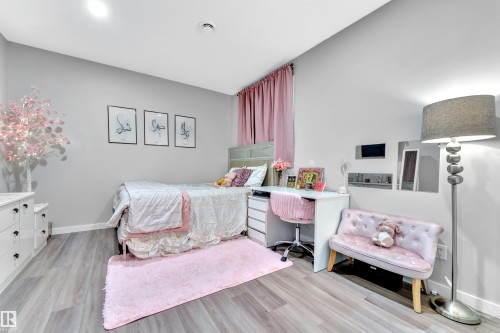 Light gray walls complement the wood-finish flooring in this room - 8025 174A Avenue, Edmonton, AB - Indoor Photo Showing Bedroom