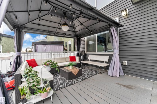 Covered outdoor patio featuring composite decking and a gazebo with string lighting - 8025 174A Avenue, Edmonton, AB - Outdoor With Deck Patio Veranda With Exterior