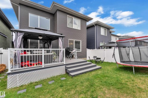 Rear exterior featuring a multi-level deck, a white lattice skirt, and a covered patio area with a gazebo - 8025 174A Avenue, Edmonton, AB - Outdoor With Deck Patio Veranda