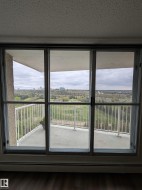 Sliding glass doors opening to a private balcony with white railing - 