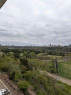 Panoramic urban skyline and expansive green spaces - 