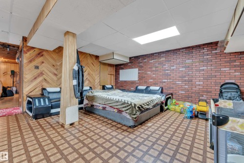 Finished interior space featuring wood-finish flooring with a geometric pattern - 4536 35A Avenue, Edmonton, AB - Indoor