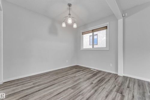 Light gray walls with wood-finish flooring - 2119 85 Street, Edmonton, AB - Indoor Photo Showing Other Room