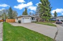 Exterior featuring light-colored siding, an attached garage with a white door, and a concrete driveway - 2119 85 Street, Edmonton, AB  - Outdoor 