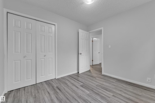 Room featuring wood-finish flooring, light gray wall paint, and white trim - 2119 85 Street, Edmonton, AB - Indoor Photo Showing Other Room