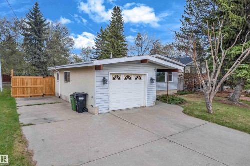 Attached single-car garage featuring a white door with decorative window inserts - 2119 85 Street, Edmonton, AB - Outdoor