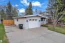 Attached single-car garage featuring a white door with decorative window inserts - 2119 85 Street, Edmonton, AB  - Outdoor 