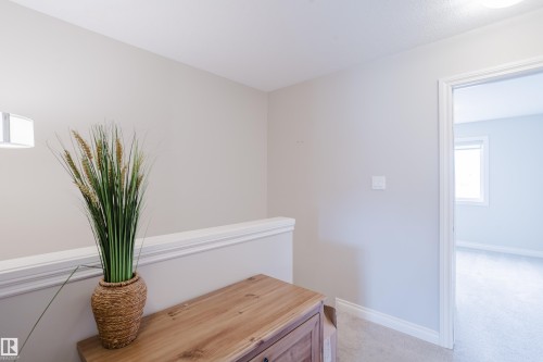 Second-story hallway featuring light neutral wall paint, white trim, and light beige carpet - 328 West Haven Drive, Leduc, AB - Indoor Photo Showing Other Room