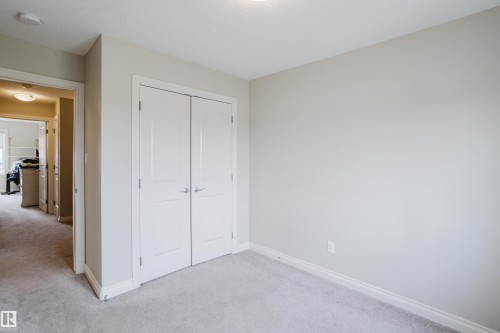 Room with light gray walls, gray carpeting, and white baseboards - 328 West Haven Drive, Leduc, AB - Indoor Photo Showing Other Room