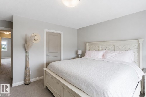 Neutral wall paint, light gray carpet flooring, white trim, and a contemporary flush mount ceiling light fixture - 328 West Haven Drive, Leduc, AB - Indoor Photo Showing Bedroom