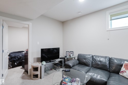 Carpeted living area with light neutral walls, recessed lighting, and a white-framed window - 328 West Haven Drive, Leduc, AB - Indoor Photo Showing Living Room