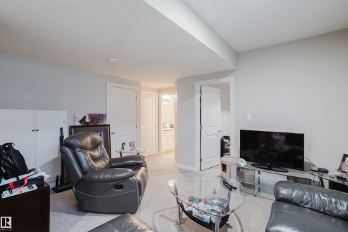 Carpeted interior space featuring light-toned walls, white trim, and a drop ceiling - 328 West Haven Drive, Leduc, AB - Indoor Photo Showing Other Room