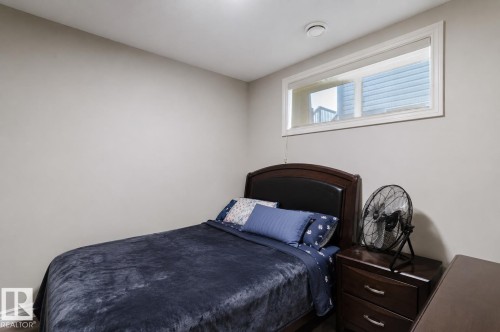 Bedroom featuring neutral wall paint, a single window with white trim, and a ceiling-mounted light fixture - 328 West Haven Drive, Leduc, AB - Indoor Photo Showing Bedroom