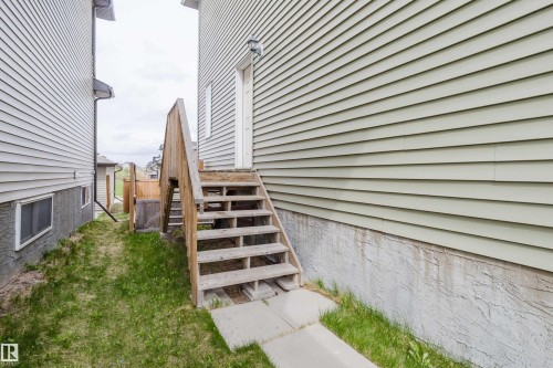 Exterior featuring light green horizontal siding and a concrete foundation - 328 West Haven Drive, Leduc, AB - Outdoor
