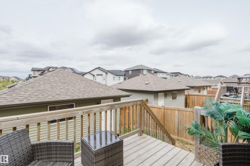 Multi-level wooden deck featuring a slatted railing and integrated steps - 328 West Haven Drive, Leduc, AB - Outdoor With Deck Patio Veranda