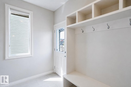Mudroom featuring built-in storage with upper cubbies, coat hooks, and a bench - 328 West Haven Drive, Leduc, AB - Indoor Photo Showing Other Room