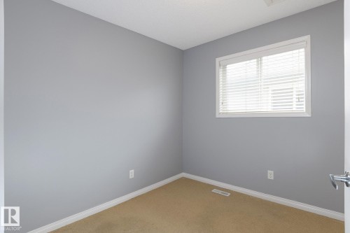 Carpeted room featuring light gray walls and white trim - 9071 Scott Crescent, Edmonton, AB - Indoor Photo Showing Other Room