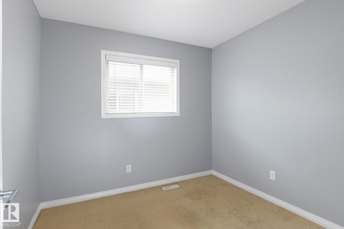 Room featuring light gray painted walls, a single window with white blinds, and beige carpet flooring - 9071 Scott Crescent, Edmonton, AB - Indoor Photo Showing Other Room