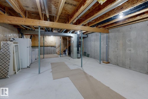 Unfinished basement with concrete flooring and exposed ceiling joists - 9071 Scott Crescent, Edmonton, AB - Indoor Photo Showing Basement