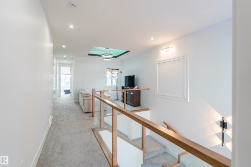 Upper-level hallway featuring light-toned carpeting and recessed lighting - 219 28 Street, Edmonton, AB - Indoor Photo Showing Other Room