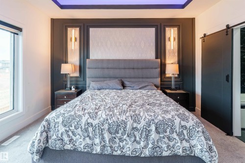 Accent wall featuring recessed paneling and integrated sconce lighting - 219 28 Street, Edmonton, AB - Indoor Photo Showing Bedroom