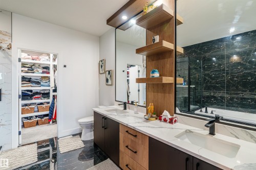 Dual vanity featuring white countertops, undermount sinks, and matte black fixtures - 219 28 Street, Edmonton, AB - Indoor Photo Showing Bathroom
