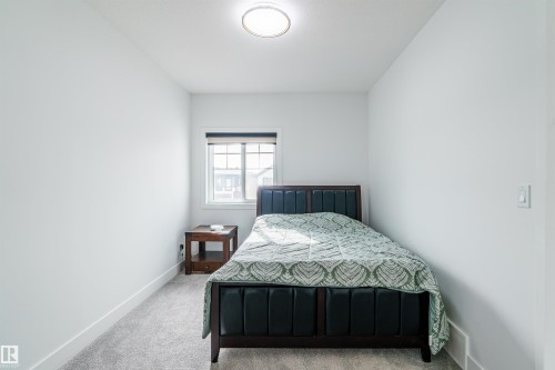 Bright room featuring light gray carpeting and white painted walls - 219 28 Street, Edmonton, AB - Indoor Photo Showing Bedroom