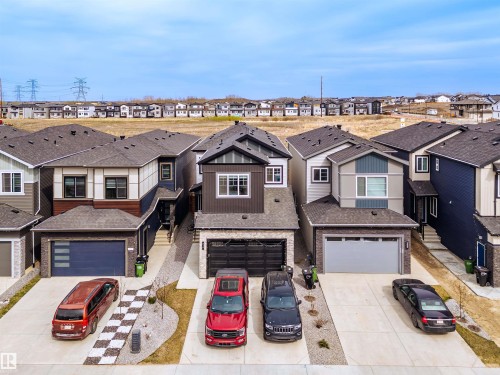 Contemporary two-story residence featuring a dark gray and brown exterior with stone accents - 219 28 Street, Edmonton, AB - Outdoor With Facade