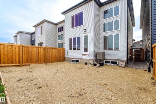 Light gray siding exterior with multiple large windows across two levels - 219 28 Street, Edmonton, AB - Outdoor With Exterior