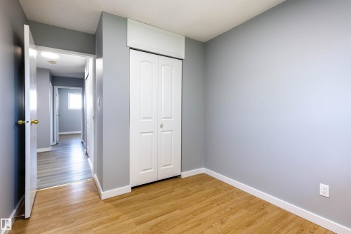 Room featuring wood-finish flooring, light grey painted walls, and white baseboards - 547 Dunluce Road, Edmonton, AB - Indoor Photo Showing Other Room