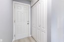 Entryway featuring a paneled door with brushed nickel hardware, light-toned wood-finish flooring, and a multi-panel bifold closet door - 547 Dunluce Road, Edmonton, AB  - Indoor Photo Showing Other Room 