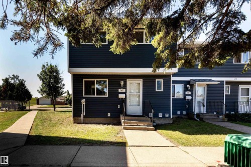 Two-story property featuring dark blue horizontal siding and white trim - 547 Dunluce Road, Edmonton, AB - Outdoor With Facade