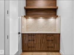 Custom built-in cabinetry featuring wood-finish paneling and dark hardware - 