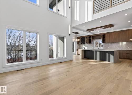 Vaulted ceilings enhance this open-concept space featuring light wood-finish flooring - 5820 110 Street, Edmonton, AB - Indoor Photo Showing Kitchen