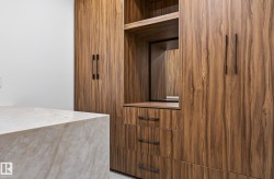 Custom built-in cabinetry with wood-finish doors and dark hardware - 