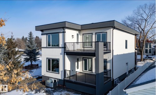 Modern multi-level residence featuring a flat roofline and dark trim accents - 5820 110 Street, Edmonton, AB - Outdoor With Balcony With Exterior