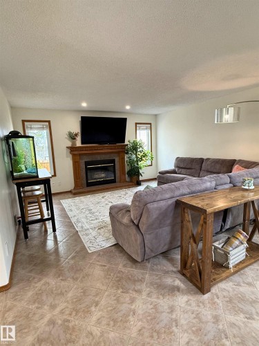 5006 59 Street, Beaumont, AB - Indoor Photo Showing Living Room With Fireplace