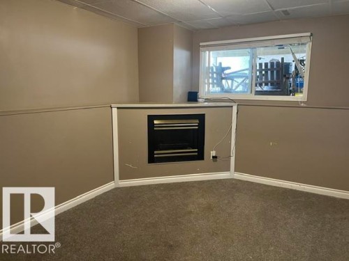 5911A 41 Avenue, Camrose, AB - Indoor Photo Showing Other Room With Fireplace