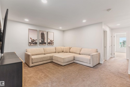 Carpeted recreation area with recessed lighting, light-toned walls, and white trim - 6003 Edmonds Place Nw, Edmonton, AB - Indoor