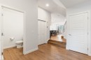 Main-level powder room featuring a white toilet and toilet paper holder - 6003 Edmonds Place Nw, Edmonton, AB  - Indoor Photo Showing Other Room 