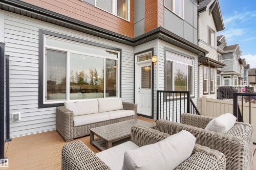 Outdoor deck area featuring composite decking and black metal railings - 6003 Edmonds Place Nw, Edmonton, AB - Outdoor With Deck Patio Veranda With Exterior