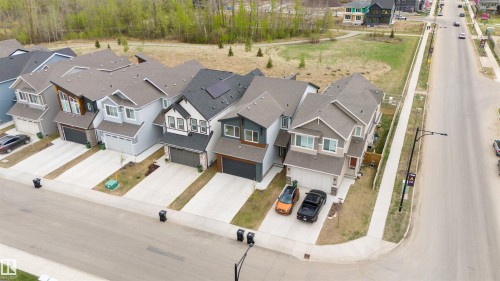 Contemporary suburban streetscape featuring multiple two-story residences - 6003 Edmonds Place Nw, Edmonton, AB - 