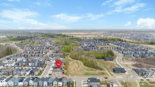 Aerial perspective of a developed residential community featuring a variety of housing styles, established streets, and surrounding green spaces - 6003 Edmonds Place Nw, Edmonton, AB - Outdoor With View