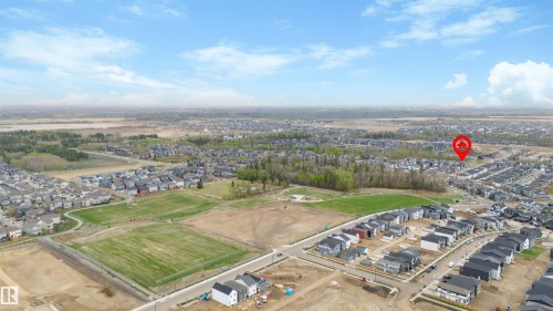 Expansive aerial perspective showcasing a residential development with numerous homes - 6003 Edmonds Place Nw, Edmonton, AB - Outdoor With View
