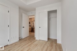 Light wood-finish flooring complements crisp white walls - 